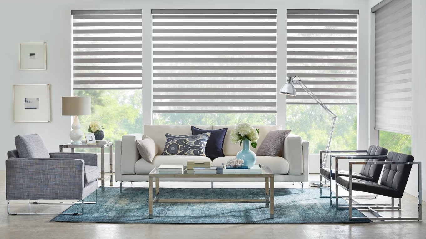 Banded rollershades in a living room area with couch