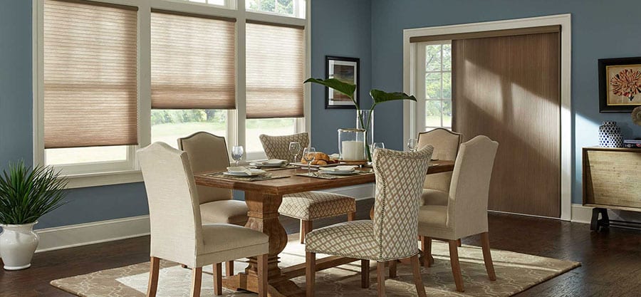 Honeycomb shades in dining room setting.