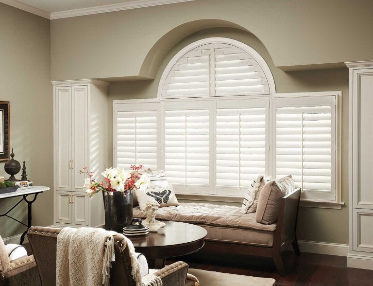 Arched window with utah shutters.
