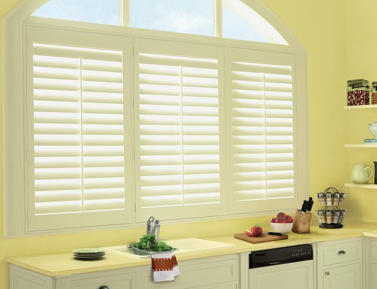Custom poly shutters above a kitchen sink.