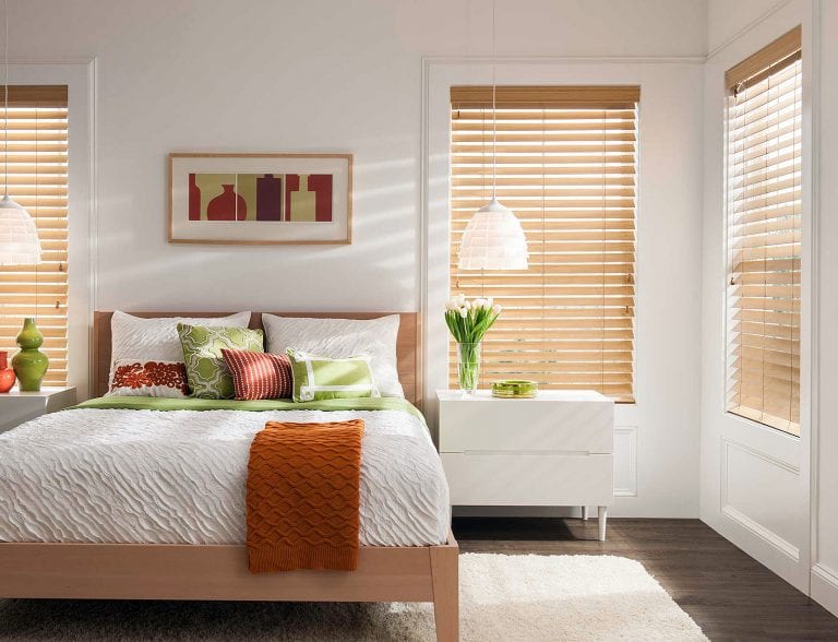 Bedroom with stained wood blinds.