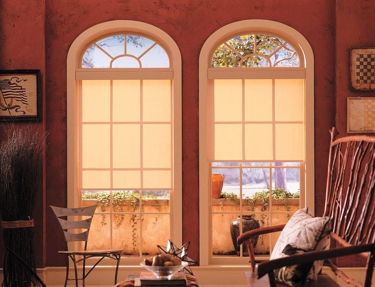 Roller shades on arched windows.