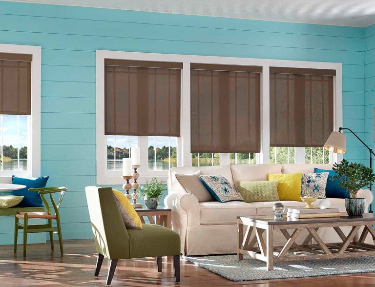 Blue room with brown woven wood shades.
