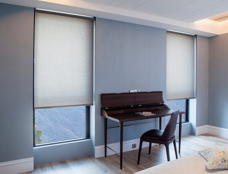 Blue office with roller shades.