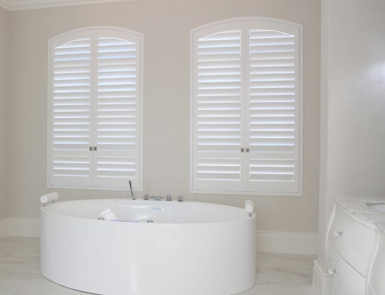 Arched bathroom shutters.