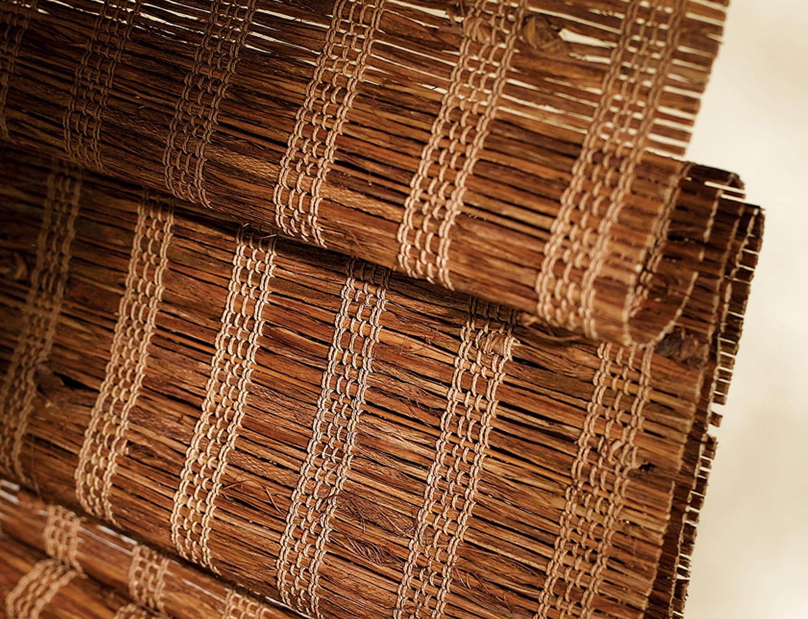 Close up view of a woven wood shutter.