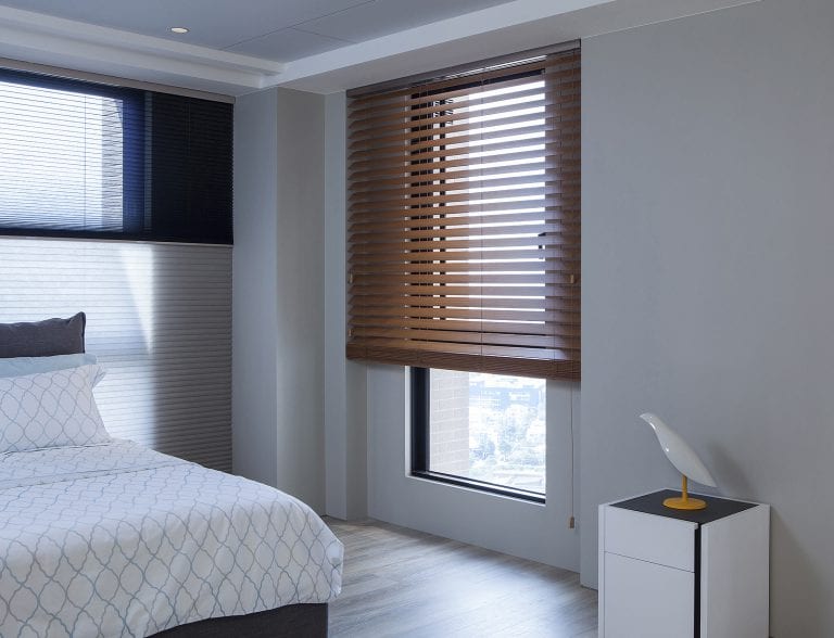 Open wood blinds on a large window.