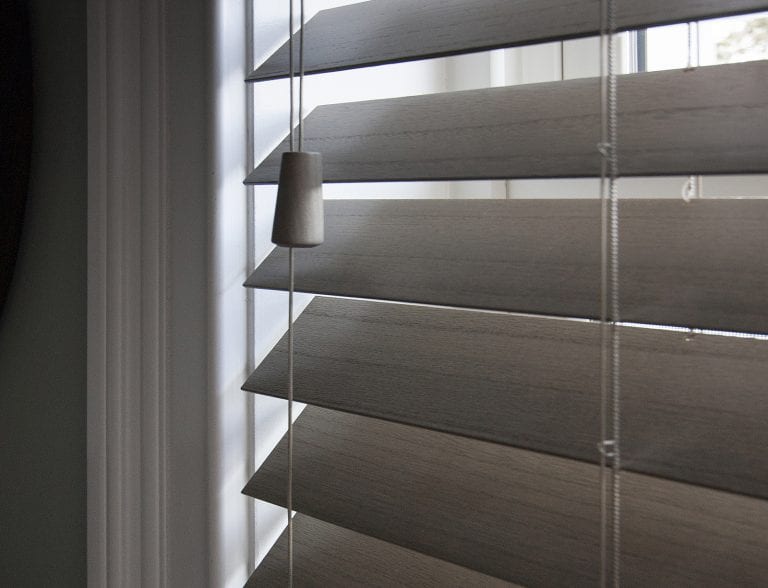Close up view of wood blinds.
