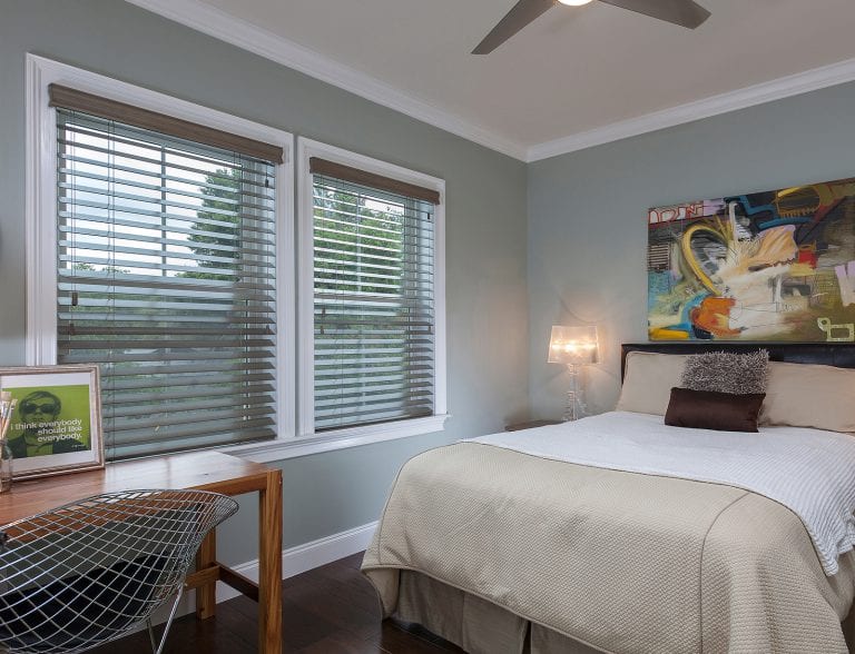 Wood blinds in a bedroom.