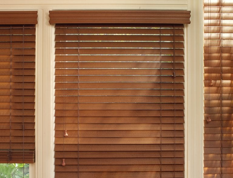 Stained wood blinds with cord controls.