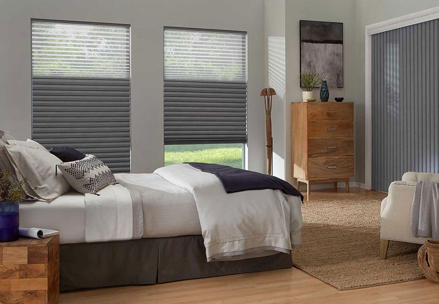 Grey window treatments in a bedroom.