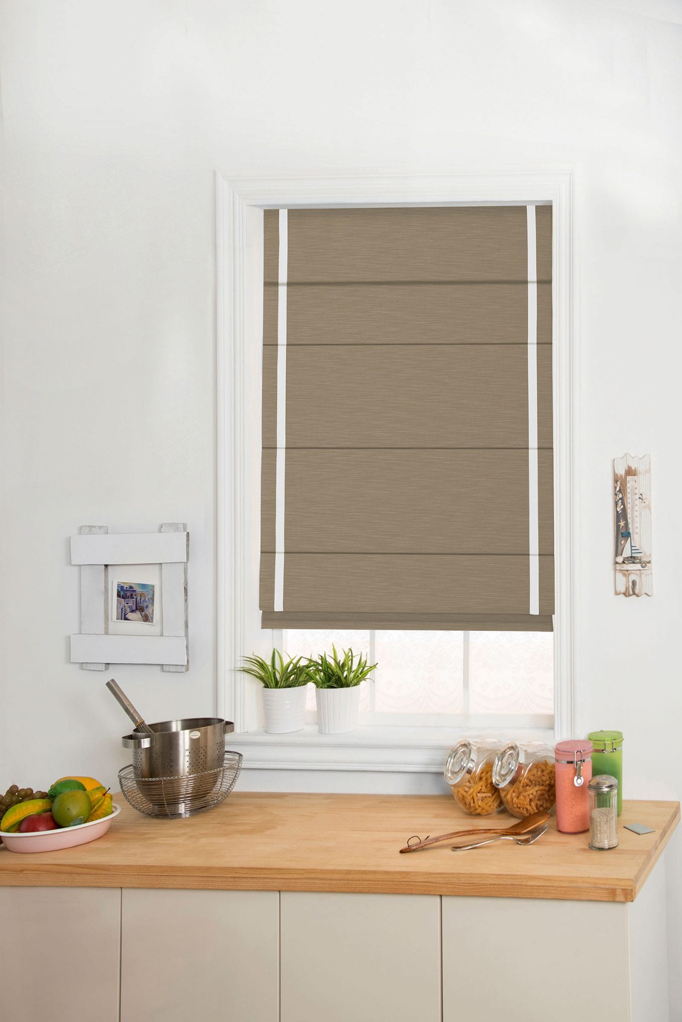 Brown roman shade with white trim.